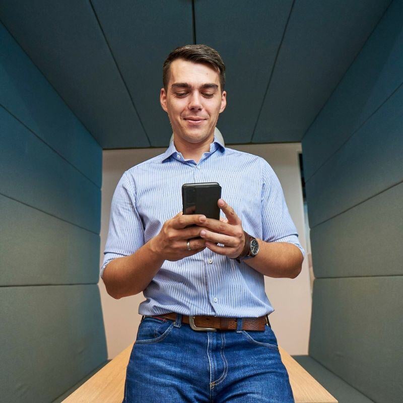 Man using his phone in Createq office in Belgrade